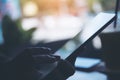 Silhouette closeup image of a woman`s hands holding and touching tablet pc in cafe Royalty Free Stock Photo