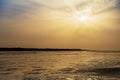 Silhouette of a cockle catcher at the beach in the island of Orango at sunset, in Guinea Bissau