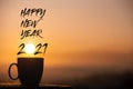 Silhouette coffee cup with happy new year 2021 text on a sunrise background Royalty Free Stock Photo