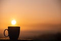 Silhouette coffee cup with the sunrise