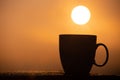 Silhouette coffee cup with the sunrise