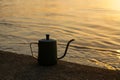 silhouette of a coffee kettle at the lake