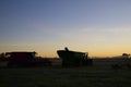 Silhouette of combine harvester on the field in the morning in Ontario, Canada