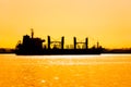 Silhouette of a commercial ship at sunset