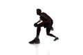 Silhouette of concentrated male athlete, basketball player in motion, dribbling ball isolated on white background Royalty Free Stock Photo