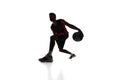 Silhouette of concentrated male athlete, basketball player in motion, dribbling ball isolated on white background Royalty Free Stock Photo