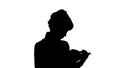 Silhouette Concentrated young business woman holding and reading book track matte