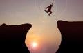 Silhouette concept idea.man jumping over cliff . Royalty Free Stock Photo