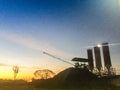 Silhouette concrete mixing plant with silos and dramatic sky background in the morning. Cement mixing silos, Stationary concrete Royalty Free Stock Photo