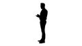 Silhouette Confident serious smart businessman having an idea and making notes.