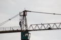 Silhouette of consruction worker on top of tower crane Royalty Free Stock Photo