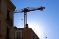 Silhouette of construction crane at construction site against blue sky. Real estate business, construction of modern Royalty Free Stock Photo