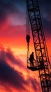 Silhouette construction crane worker sunset sky industrial steel hook platform blend with dramatic light and quiet focus on Royalty Free Stock Photo
