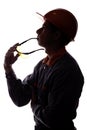 Silhouette of a construction worker dreaming of a career, a man in a helmet on a white isolated background