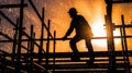 Silhouette of a construction worker on scaffolding at sunset Royalty Free Stock Photo