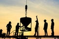 Silhouette of construction worker stand on scaffolding framework casting concrete column in construction site during beautiful sun Royalty Free Stock Photo