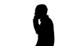 Silhouette Cool young man with beard walking and talking with mobile phone. Royalty Free Stock Photo