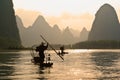 Cormorant fishermen on bamboo rafts in river, China Royalty Free Stock Photo