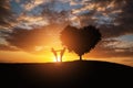 Silhouette of a couple in abstract field with heart shape tree with sunset.Romance and Valentine concept background.