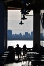 The silhouette of a couple as they sit outside of a cafe overlooking the sea. Royalty Free Stock Photo