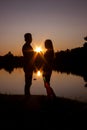 Silhouette of couple on the beach looking at sunrise Royalty Free Stock Photo
