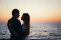 Silhouette of a couple at the beach at sunrise sky summer time, seashore summer beach at yellow blue evening horizon sea, sunset b Royalty Free Stock Photo