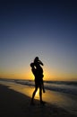 Silhouette of couple on beach at sunset Royalty Free Stock Photo