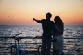 Silhouette of a couple with bikes at the beach at sunrise sky summer time, seashore summer beach at yellow blue evening horizon se Royalty Free Stock Photo