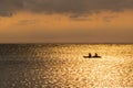 Silhouette of a couple on a canoe boat during sunset Royalty Free Stock Photo