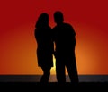 Silhouette Couple at Coastal Sunset Royalty Free Stock Photo