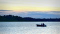 BEMIDJI, MN - 10 JULY 2016: Silhouette of couple fishing in a boat on a lake in Minnesota