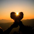 Silhouette of couple hands holding heart shape at the sky sunset background Royalty Free Stock Photo