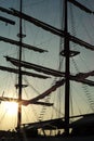 Silhouette of couple high mast on the big sailboat with clear sky of sunset in background Royalty Free Stock Photo