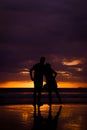 Silhouette of couple hold each other hand and Happy Young Couple love on the beach at sunset time Royalty Free Stock Photo