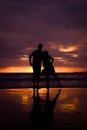 Silhouette of couple hold each other hand and Happy Young Couple love on the beach at sunset time Royalty Free Stock Photo