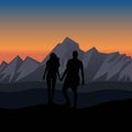 Silhouette of a couple holding hands while enjoying the view of the mountains