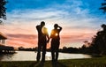The silhouette of the couple is holding hands and looking at the Royalty Free Stock Photo
