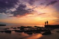 Silhouette of couple holding hands and looking at the sunset on the sea beach in beautiful time Royalty Free Stock Photo