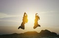 Couple jumping at sunset time. Royalty Free Stock Photo