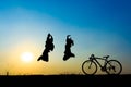 Silhouette couple jumping
