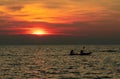 Silhouette of couple are kayaking in the sea at sunset. Kayak in the tropical sea at sunset. Romantic couple travel on summer Royalty Free Stock Photo