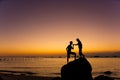 Silhouette of couple kiss on the beach at the sunrise and sunset Royalty Free Stock Photo