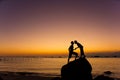 Silhouette of couple kiss on the beach at the sunrise and sunset Royalty Free Stock Photo