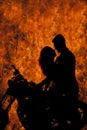 Silhouette couple kiss on motorcycle fire