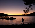 Silhouette of couple kissing on the lake at sunset Royalty Free Stock Photo