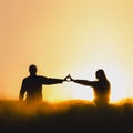 Silhouette of couple in love in beautiful morning wheat field, shape of heart from hands. Valentine photo full of love Royalty Free Stock Photo