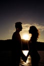 Silhouette of couple in love holding hands on the sunset Royalty Free Stock Photo