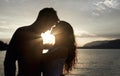 Silhouette, couple and love by ocean at sunset, vacation or travel together in summer. Man, woman and romance at sea Royalty Free Stock Photo