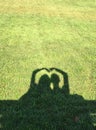 Silhouette of Couple making heart-shaped shadow
