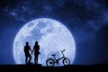 Silhouette couple man and woman holding hand Full moon night With a Bicycle and birds that fly back to the nest. Mixed media. Royalty Free Stock Photo